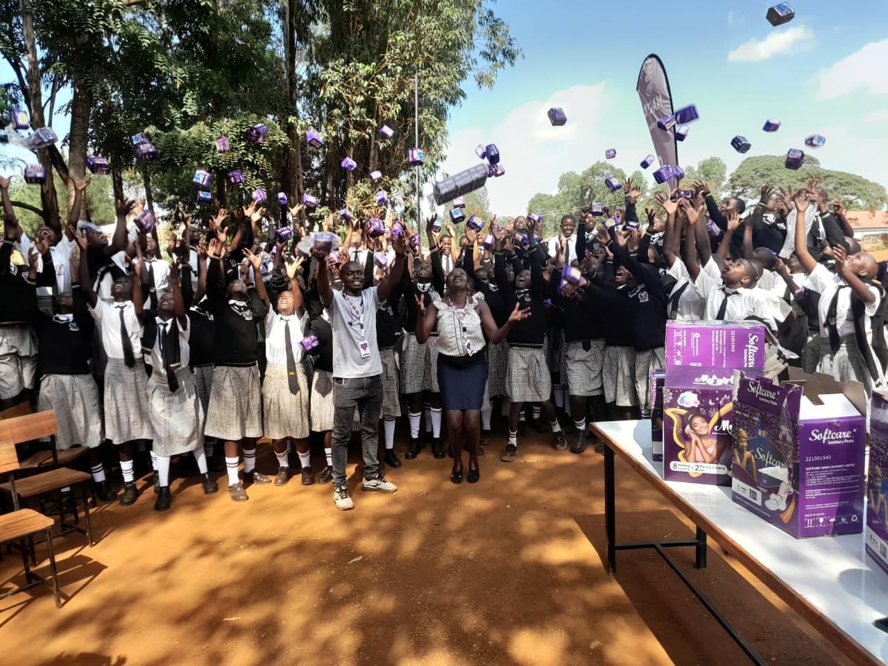 NALFA C.B.O. members holding sanitary pads during a community menstrual hygiene outreach in Siaya County.