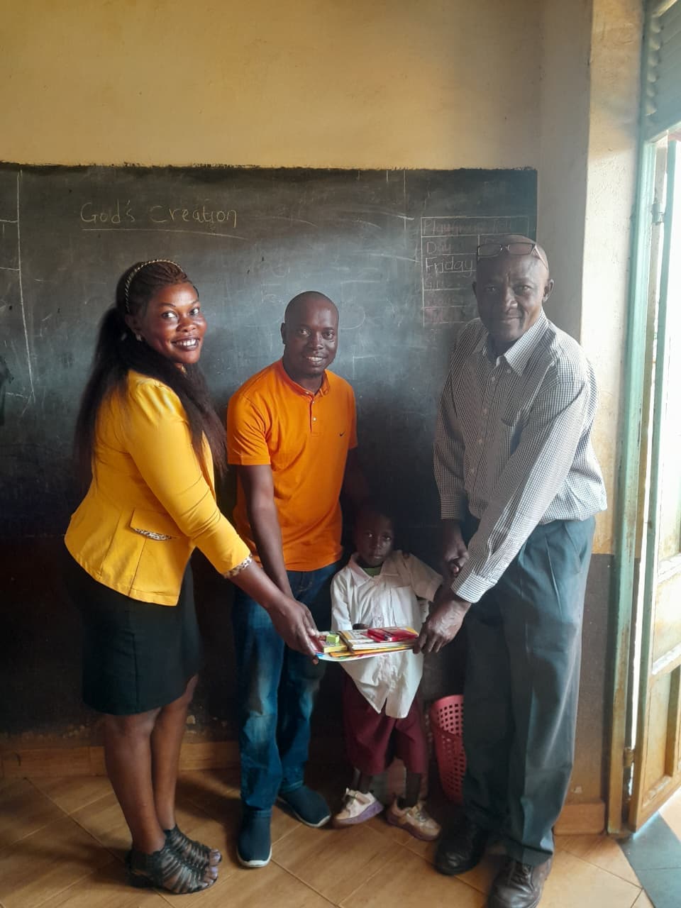 volunteers presenting learning materials to a child with a disability during a community education support program.