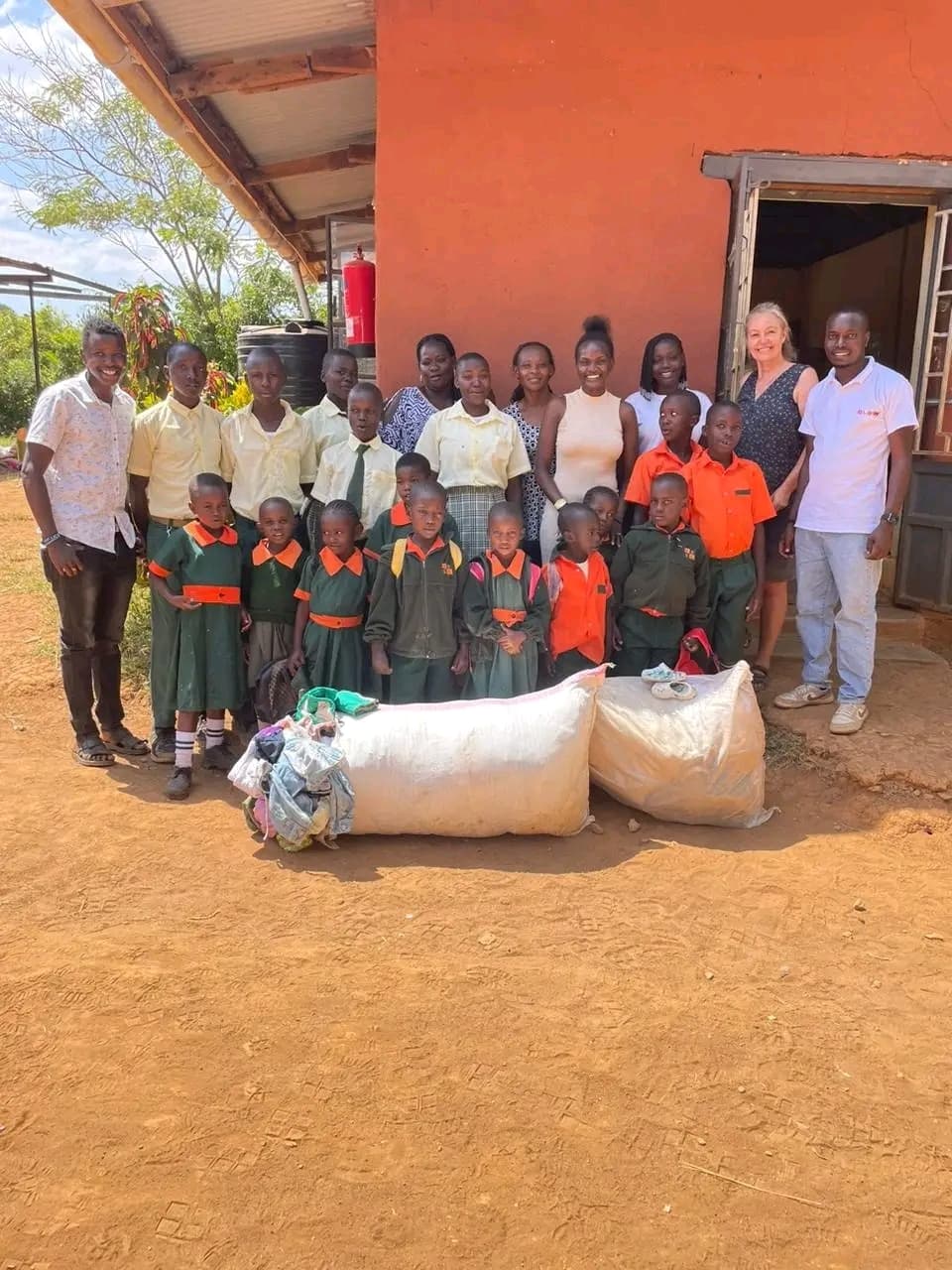 NALFA CBO volunteers donating clothes to children at Mbaga Children Home in Siaya County, Kenya.