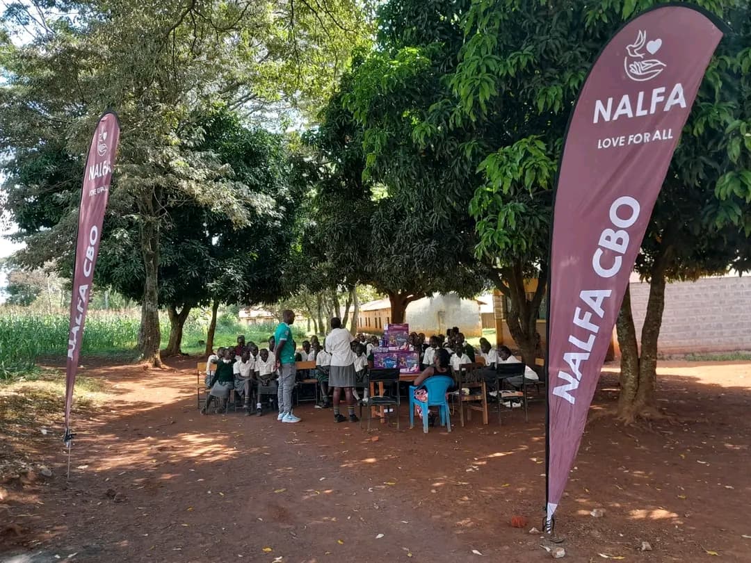 Girls at Mulaha Junior Secondary School receiving sanitary pads from NALFA CBO during a menstrual hygiene education and sanitary pads donation programme in Siaya County, Kenya.