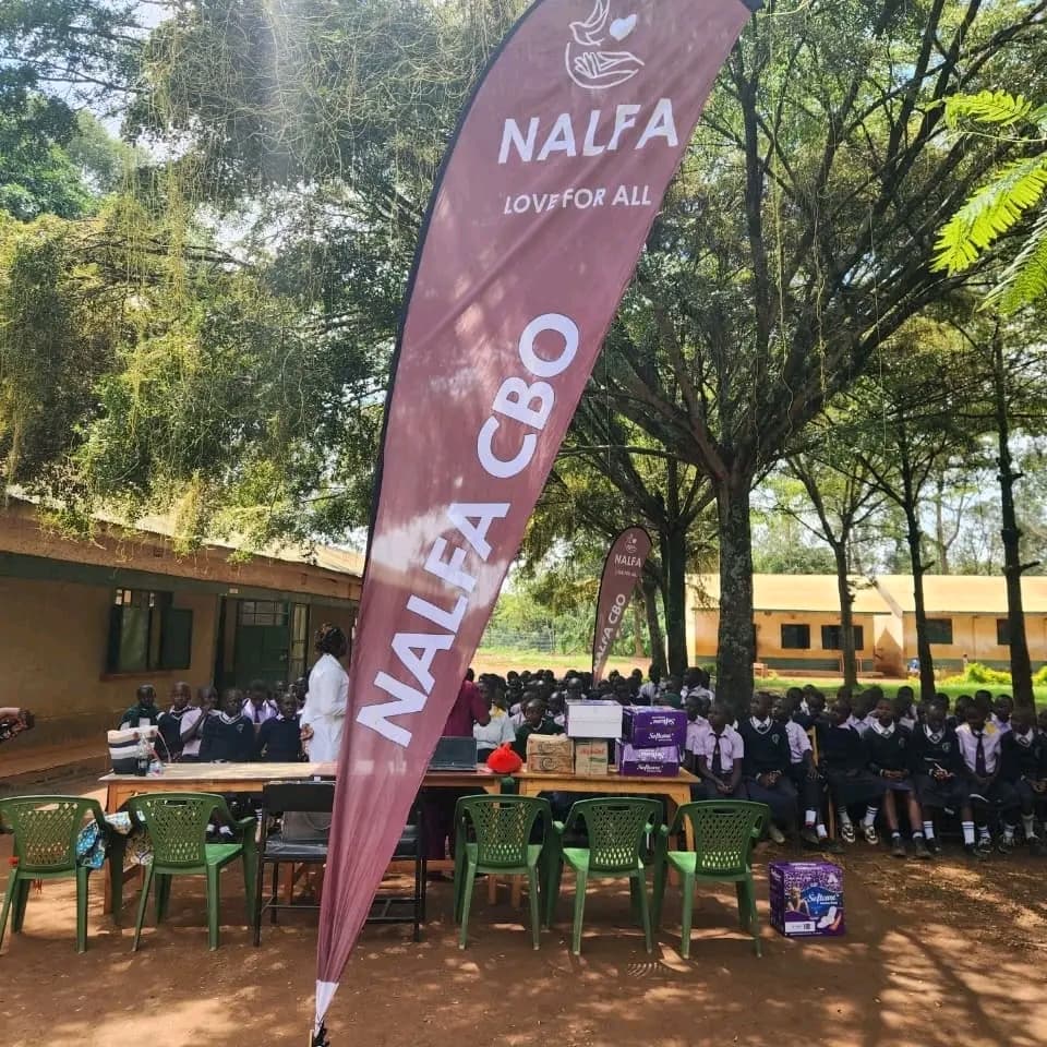 Girls at Ngunye Junior Secondary School in Ugenya receiving sanitary towels from NALFA CBO during a menstrual hygiene support programme.