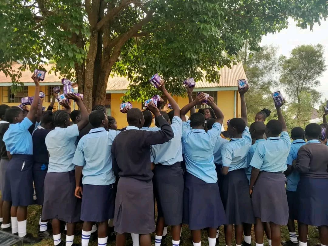 Girls at Usula Junior Secondary School receiving sanitary towels from NALFA CBO during a menstrual hygiene education and donation programme in Siaya County, Kenya.