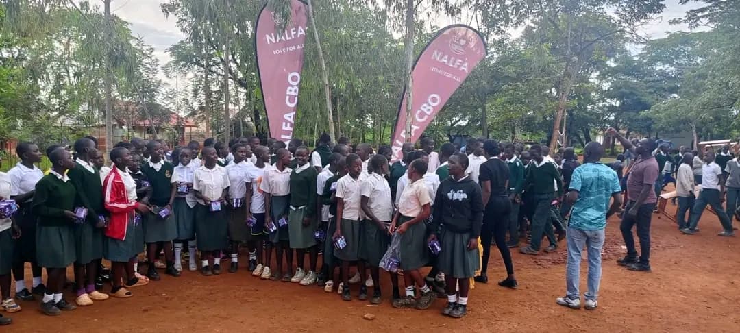 NALFA CBO volunteers donating sanitary pads to girls at Gendro Junior Secondary School in Siaya County, Kenya