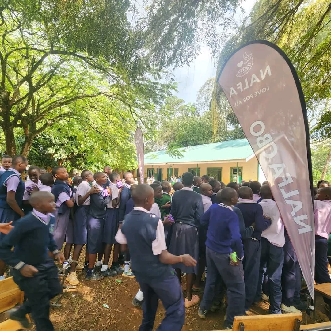 NALFA CBO volunteers distributing bathing soap to boys at Ngunya Junior Secondary School in Siaya County, Kenya.