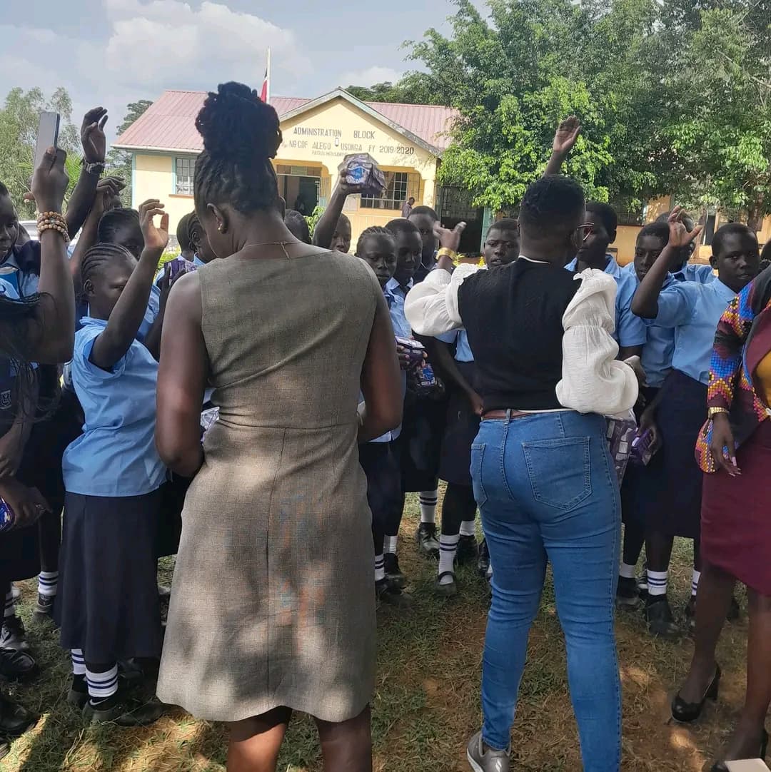 NALFA CBO volunteers distributing sanitary pads to girls at Usula Senior School in Siaya County.